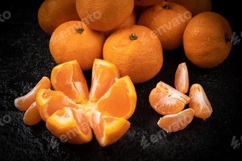 Preview: Juicy mandarin on black background. Mandarin Fruit