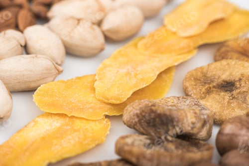 Preview: close up view of pistachio nuts, dried mango and figs isolated on white