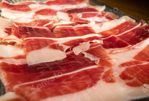 Preview: Slices spanish dried pork also known as Jamon Serrano. Typical tapa Iberian ham