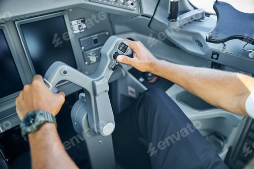 Preview: Male pilot in cockpit flying passenger plane