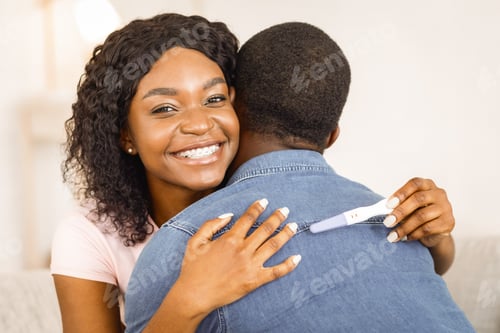 Preview: Black girl with pregnancy test hugging her boyfriend