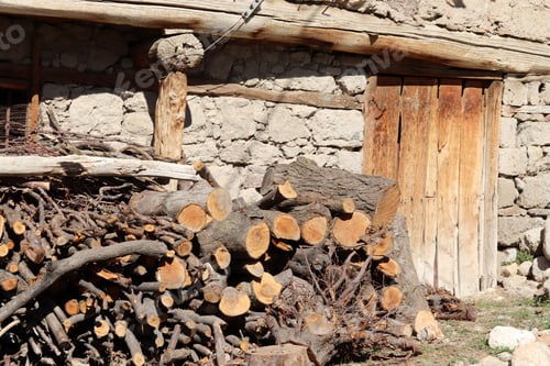 Preview: Stacked firewood pile near rural house Wall