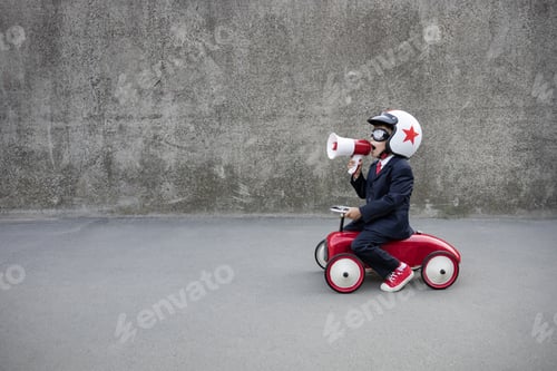 Preview: Funny businessman driving retro kids car outdoor