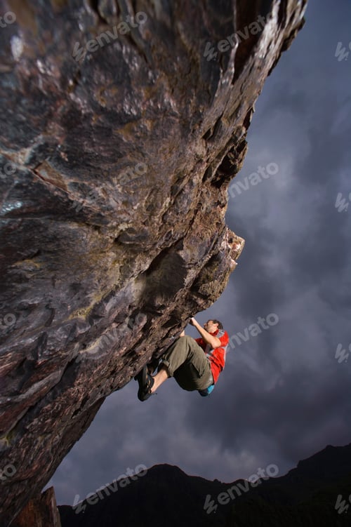 Preview: Climber bouldering on a rock face.