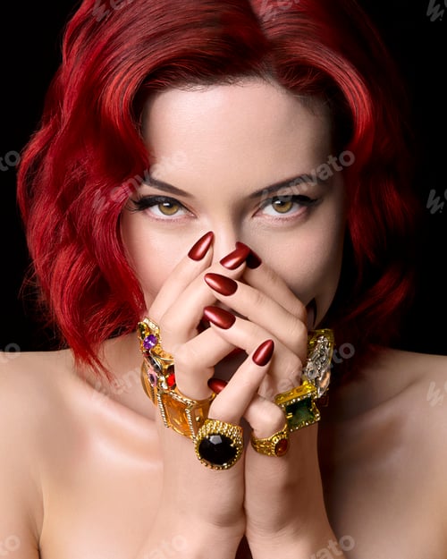 Preview: Portrait of young woman with red hair, hands covering face, wearing rings on all fingers