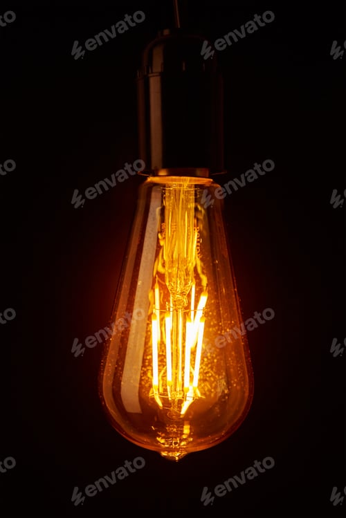 Preview: Glowing Filament: Vintage Edison Bulb on Black Backdrop