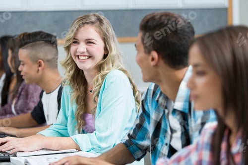 Preview: Row of teenage high school students smiling in computer class