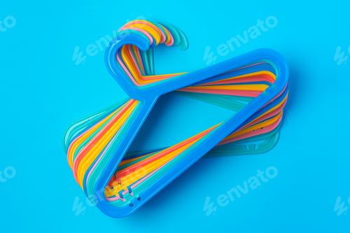 Preview: Blue hanger on trendy blue color background. Template fashion blog social media.