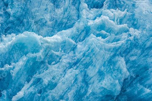Preview: Closeup shot of the ice texture of a blue glacial wall in Inside Passage, Alaska