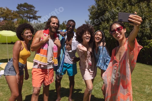 Preview: Diverse group of friends taking selfie at a pool party
