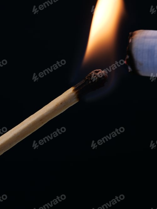 Preview: Vertical closeup of a matchstick lighting a cigarette
