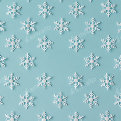Preview: Winter pattern made of snowflakes on blue background. Winter concept. Flat lay.