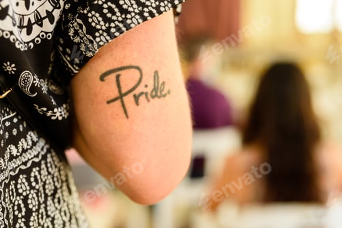 Preview: Detail of the arm of a participant in the gay pride festival, with the word Pride drawn on the arm.
