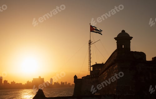 Preview: Cuban flag over El Morro Fortress at sunset, Havana, Cuba