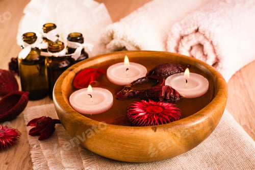 Preview: Items for spa treatments. Candles, essential oils, water, flowers and towels.