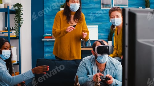 Preview: Diverse friends trying to win playing video games experiencing vr headset