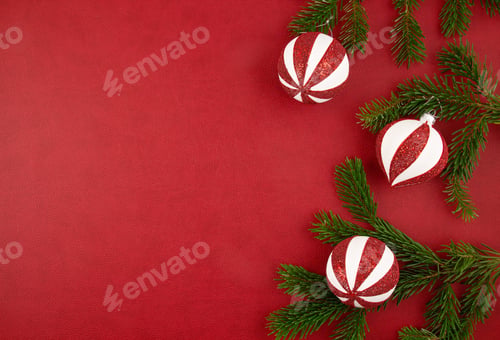 Preview: Christmas decoration with xmas ornaments, pine tree, gifts with copy space over the red background