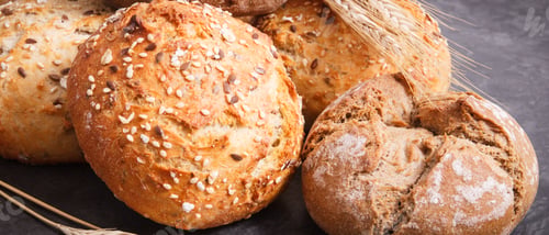 Preview: Wholegrain rolls or bread for breakfast and ears of rye or wheat grain