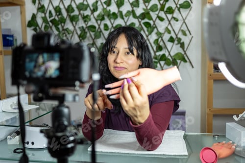 Preview: Young Mexican woman recording a manicure tutorial