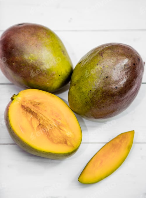 Preview: Mango fruits closeup on white wooden background,