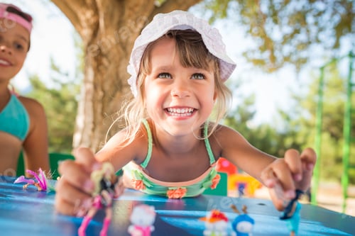 Preview: Two little cute girls playing dolls outdoors