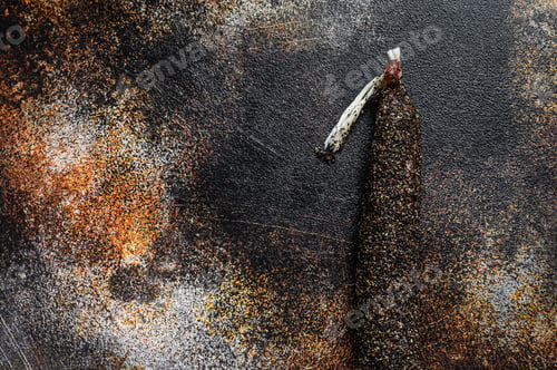 Preview: Fuet, Salami. Traditional Spanish sausage. Black background. Top view. Space for text