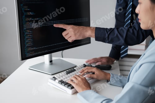 Preview: Team of programmer pointing to desktop computer with developing programming code, trying to solve th