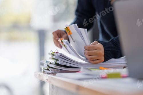 Preview: Asian Business woman using calculator and laptop for doing math finance an office desk, tax, report,