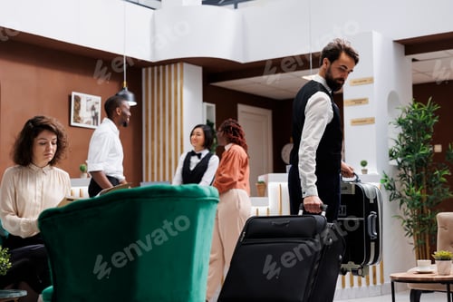 Preview: Male hotel porter carrying luggage
