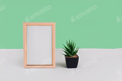 Preview: Blank white vertical photo frame on green background.