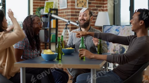 Preview: Cheerful men and women laughing at cards game play