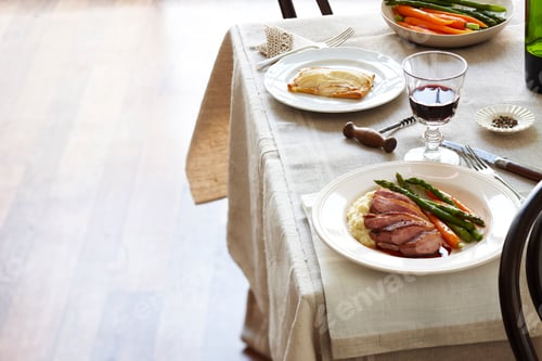 Preview: Elegant dining table setup with gourmet food and wine.