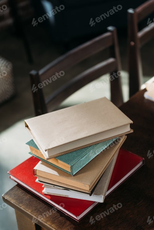 Preview: close up of heap of books on wooden tabletop with copy space