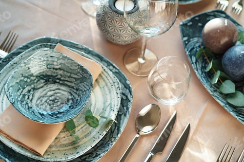 Preview: Beautiful elegant table setting with green stylish dishware and silver cutlery