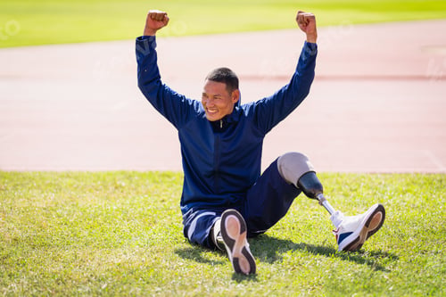 Preview: Asian para-athletes with prosthetic blades sprint on a running track at stadium.