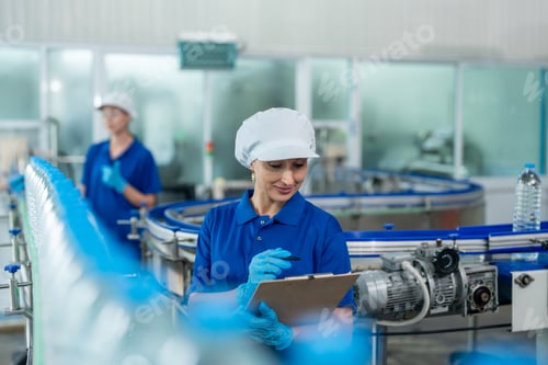 Preview: Caucasian female industry worker team working in factory warehouse.