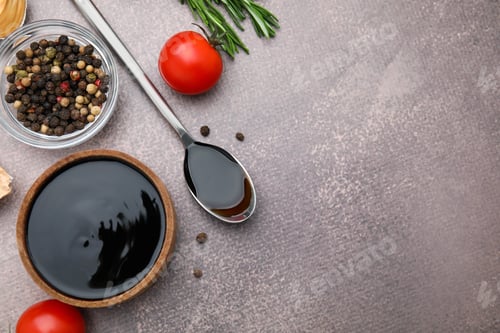 Preview: Organic balsamic vinegar and cooking ingredients on grey table, flat lay. Space for text