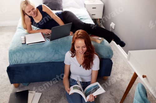 Preview: Two Female College Students In Shared House Bedroom Studying Together
