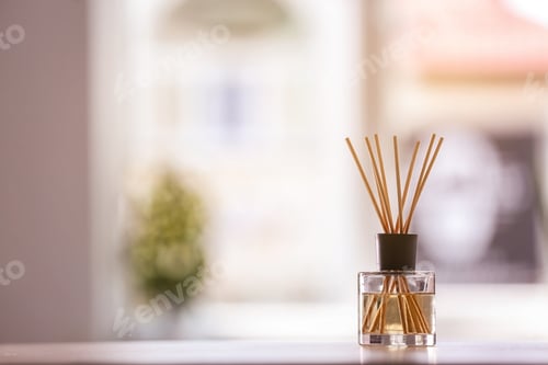 Preview: Aromatic reed air freshener on table against blurred background