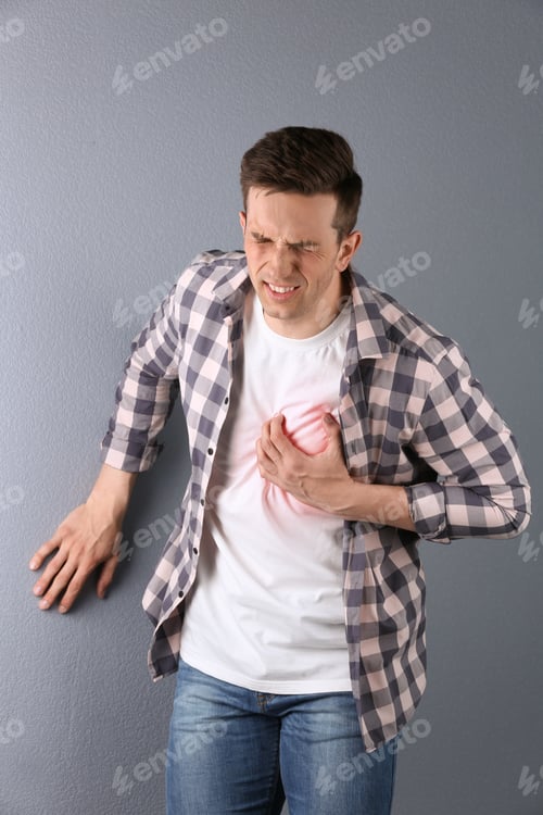 Preview: Young man having heart attack on color background