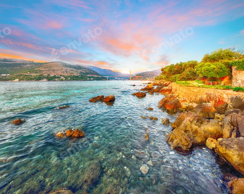 Preview: Panorama of impressive Franjo Tudjman bridge at sunset and rocky shore of Dubrovnik.