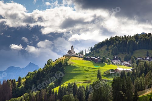 Preview: Rocca Pietore village, with his small church located at the foot of the Marmolada, Dolomites