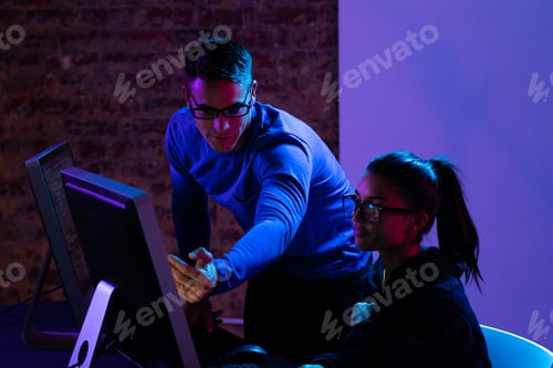 Preview: Caucasian man and a mixed race woman working late in a customer support office