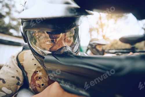 Preview: Paintball gun, man and aim with focus, camouflage clothes or helmet as shooting sniper in military