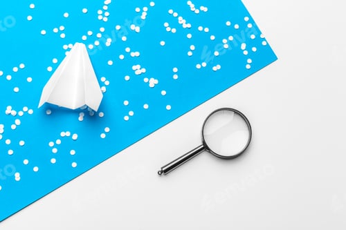 Preview: paper plane with office supplies on blue background