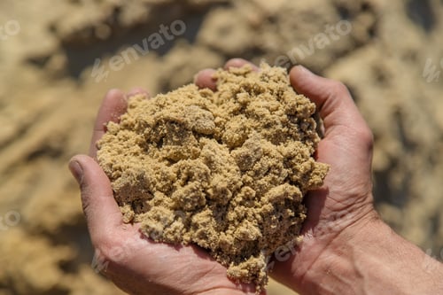 Preview: Sand in the hands of a man. Selective focus.