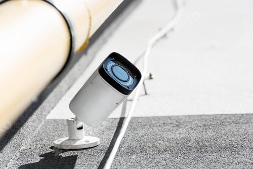 Preview: bottom view of one security camera on wall, security system concept