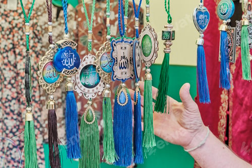 Preview: Muslim colorful amulets with Arabic script, hanging for sale.