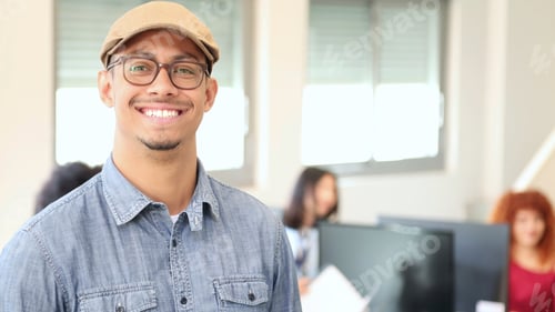 Preview: portrait of smiling young latin office worker man in an office