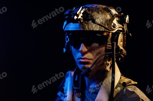 Preview: Portrait of special forces soldier in helmet and glasses in the dark